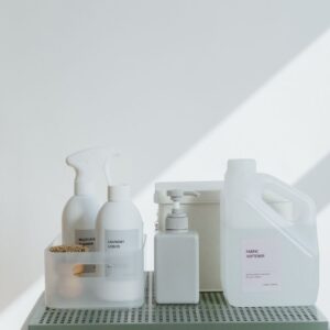 Clean and simple display of various cleaning products in soft lighting on a white background.