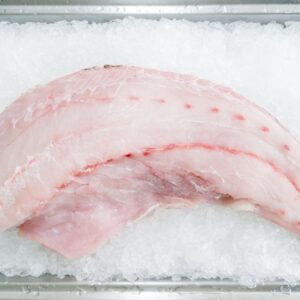 Top view of fresh fish fillet on ice, showcasing freshness and quality for culinary uses.