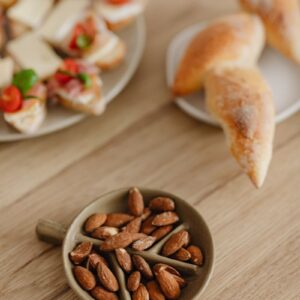 A high angle view of almonds, croissants, and bruschetta on a wooden table, perfect for food photography.