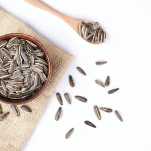 Sunflower seeds in a bowl and on a spoon.