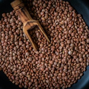 a pan filled with beans and a wooden spoon